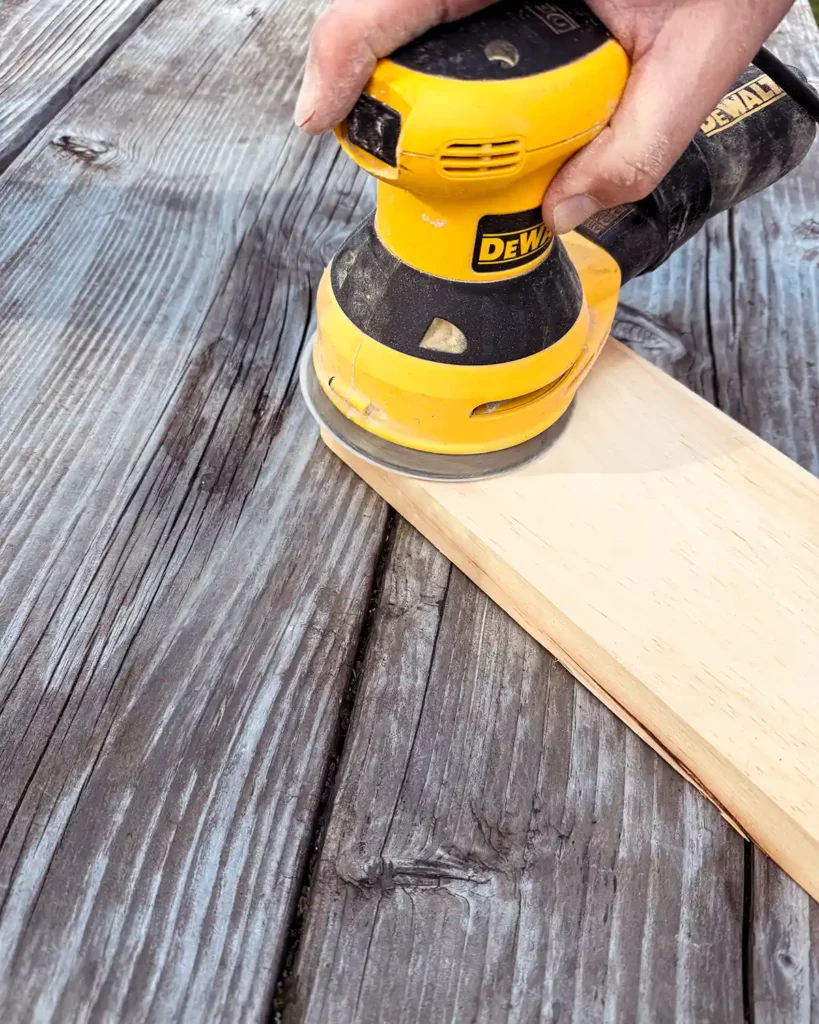 Using a Dewalt orbital sander to sand a pine board smooth
